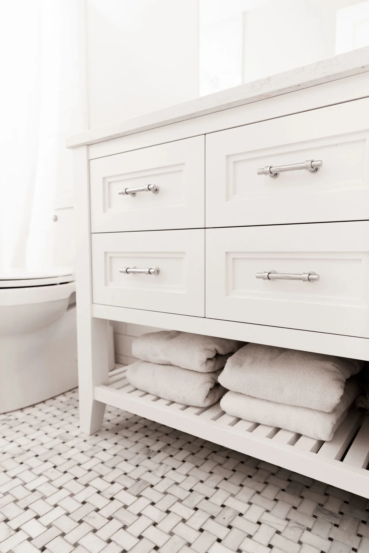 white vanity cabinet with towels, tile floor, Kitchens & Vanities
