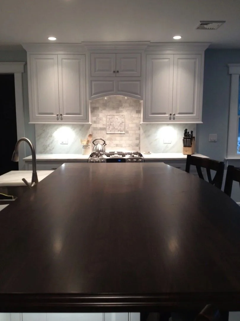 gray kitchen with dark island and marble backsplash, Kitchens & Vanities
